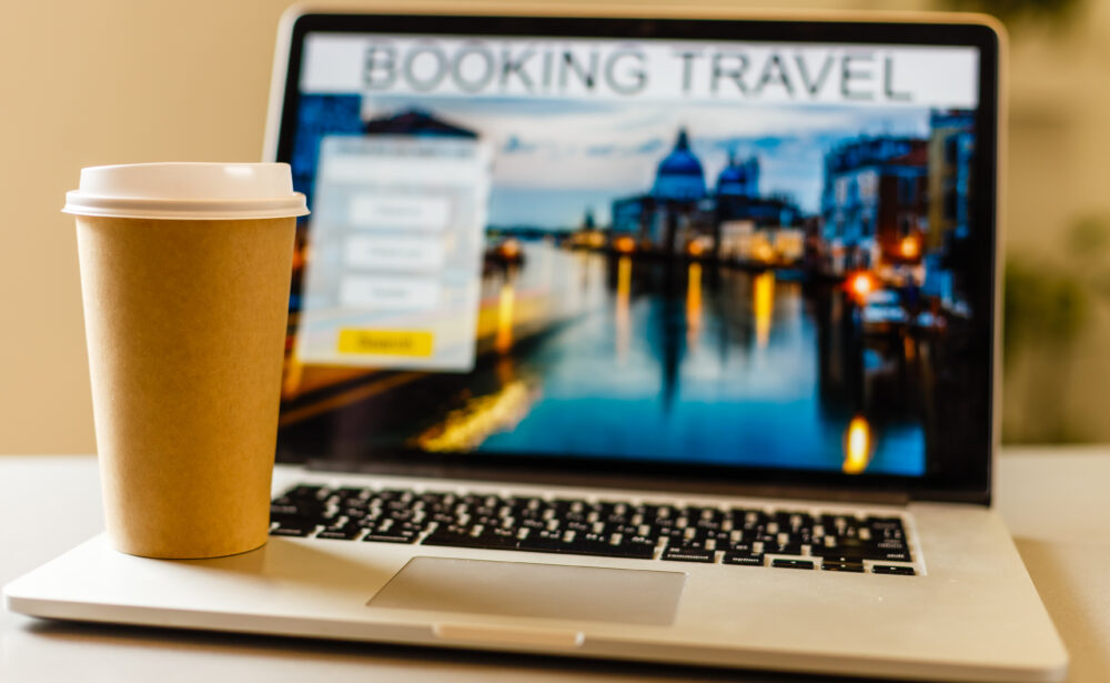 e-commerce-concept-travel-online-craft-paper-coffee-cup-near-laptop-1000x615